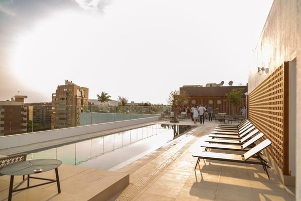 a group of people sitting at tables on a rooftop