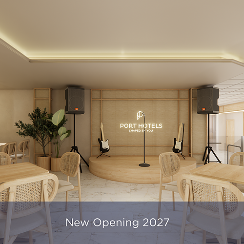 Interior of a hotel lounge with a stage, guitars, speakers, and seating. Port Hotels: Corporativa