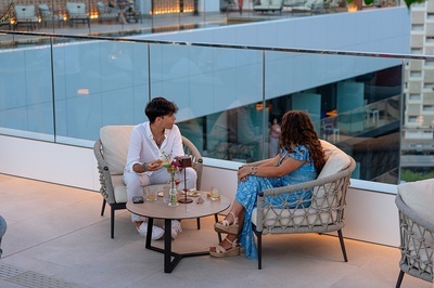 a man and a woman sit at a table with drinks - 