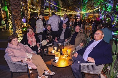 a group of people sitting around a table with drinks - 