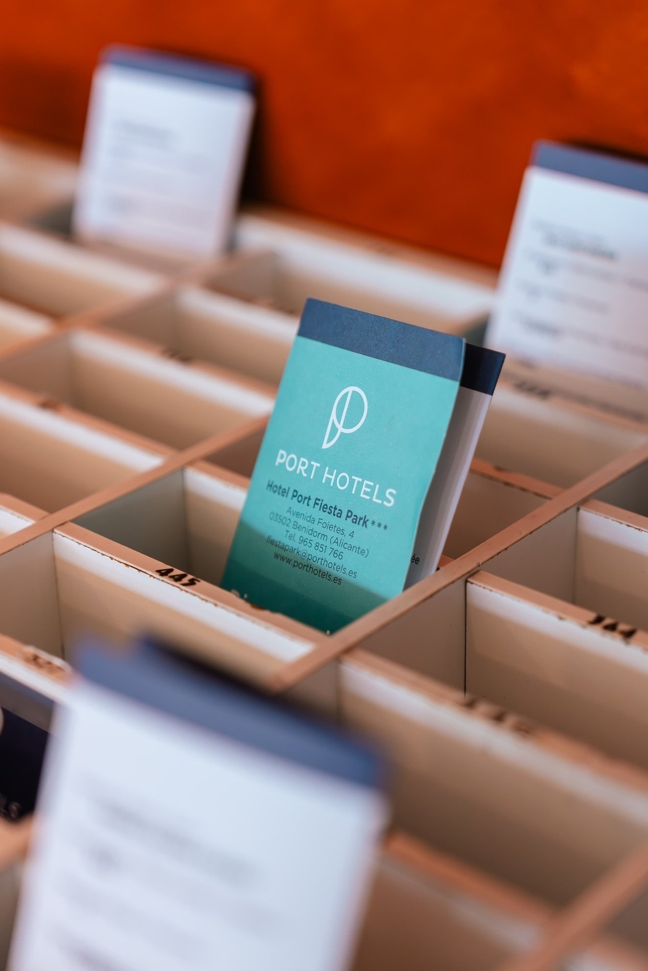 a business card for port hotels sits in a box