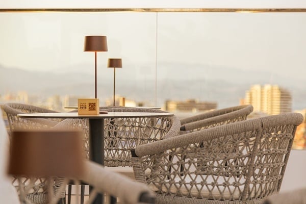 a group of people sitting at tables on a rooftop