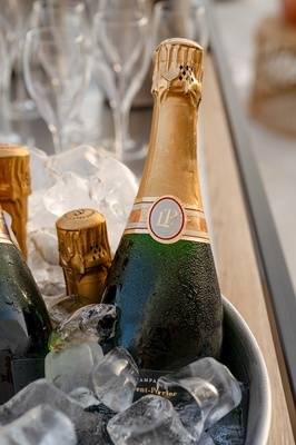 a bottle of champagne sits in a bucket of ice - 