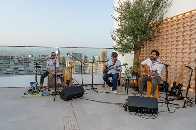 a man playing a guitar and another man playing drums - 