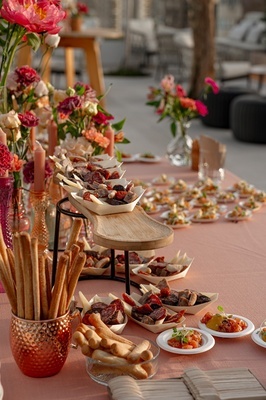 a table with plates of food and flowers on it - 