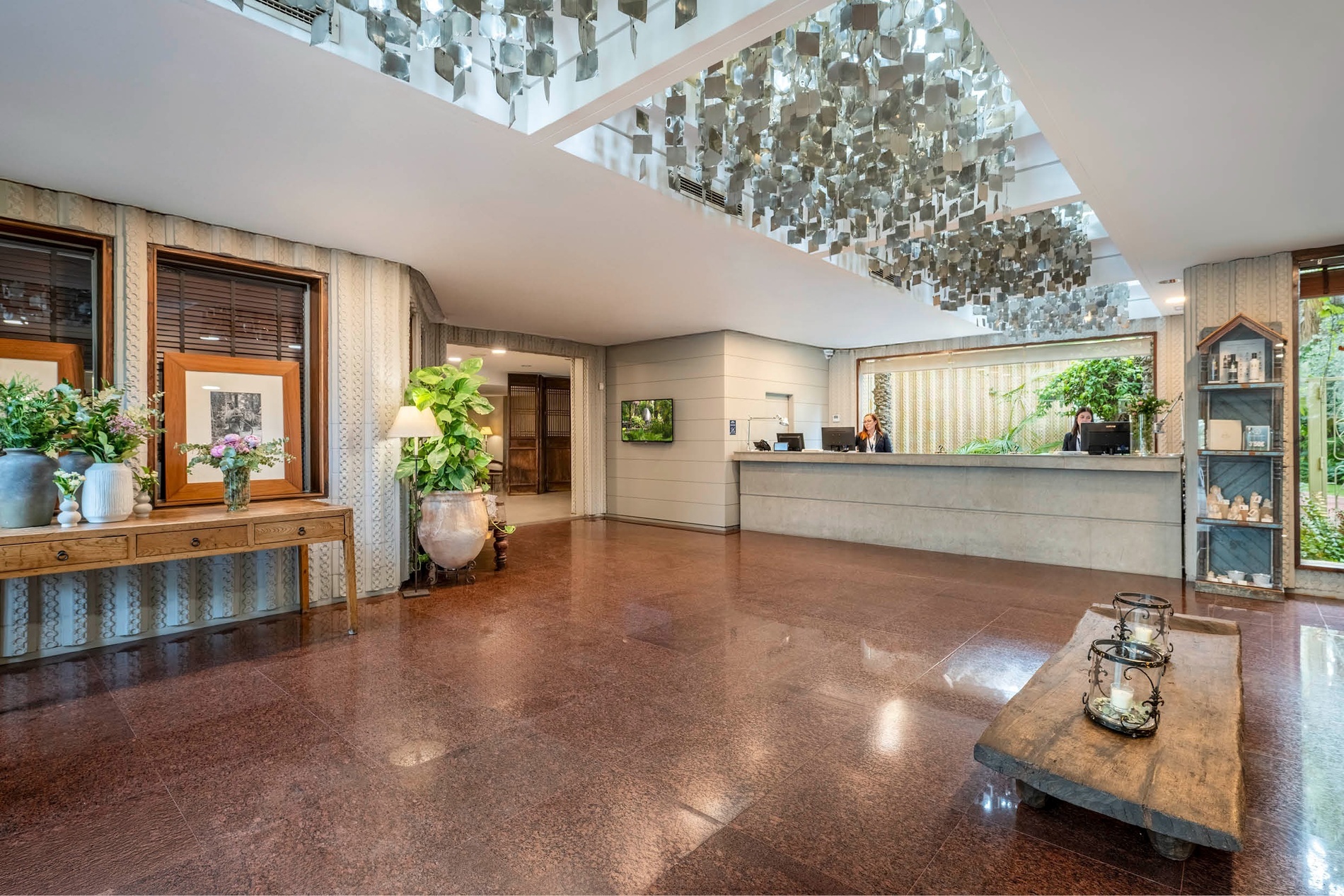 a hotel lobby with a reception desk and a table