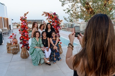 a woman is taking a picture of a group of women - 