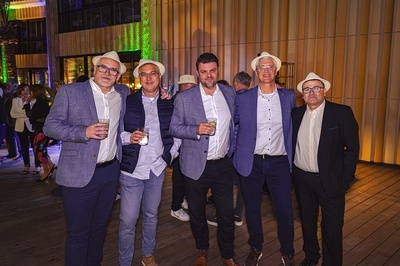 a group of men posing for a picture while wearing hats - 