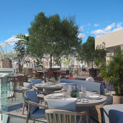 una terraza con mesas y sillas y una vista de la ciudad