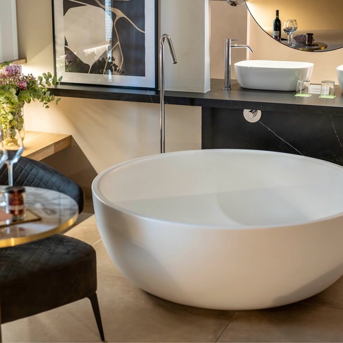 a bathroom with a bathtub and two sinks