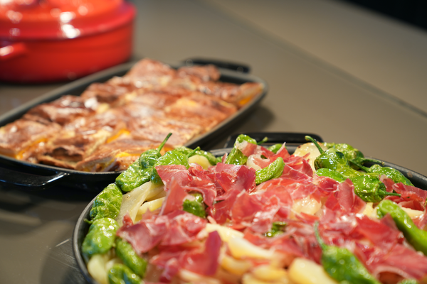 a tray of broccoli sits on a table next to a pot of food