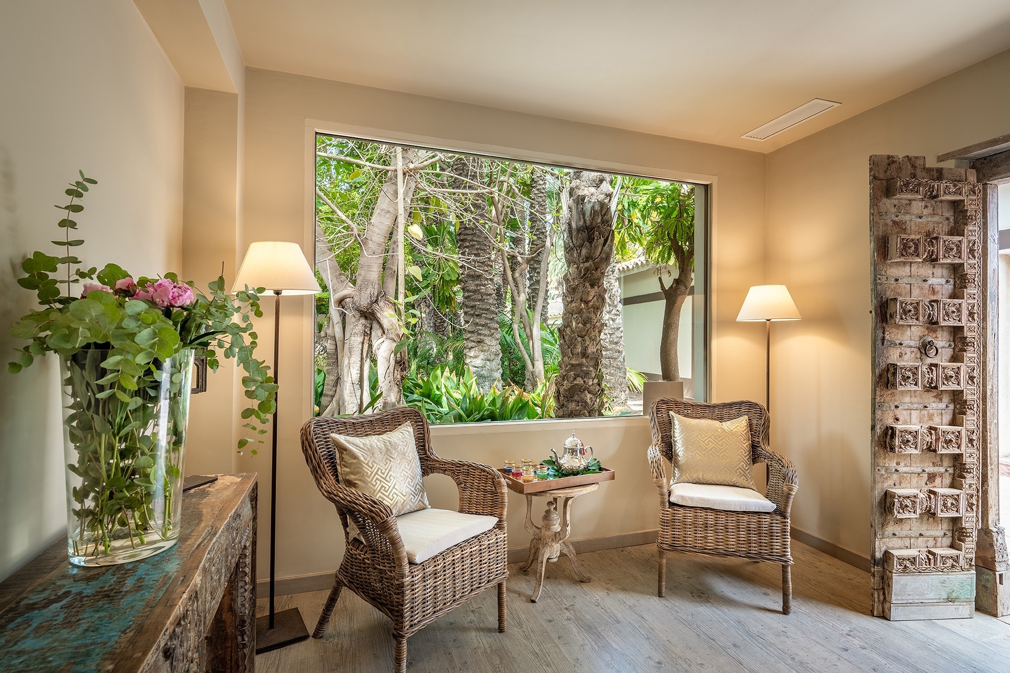 a hot tub is surrounded by lounge chairs under a wooden roof