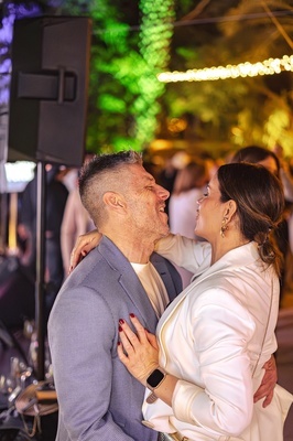 a man and woman are dancing and the woman is wearing a smart watch - 