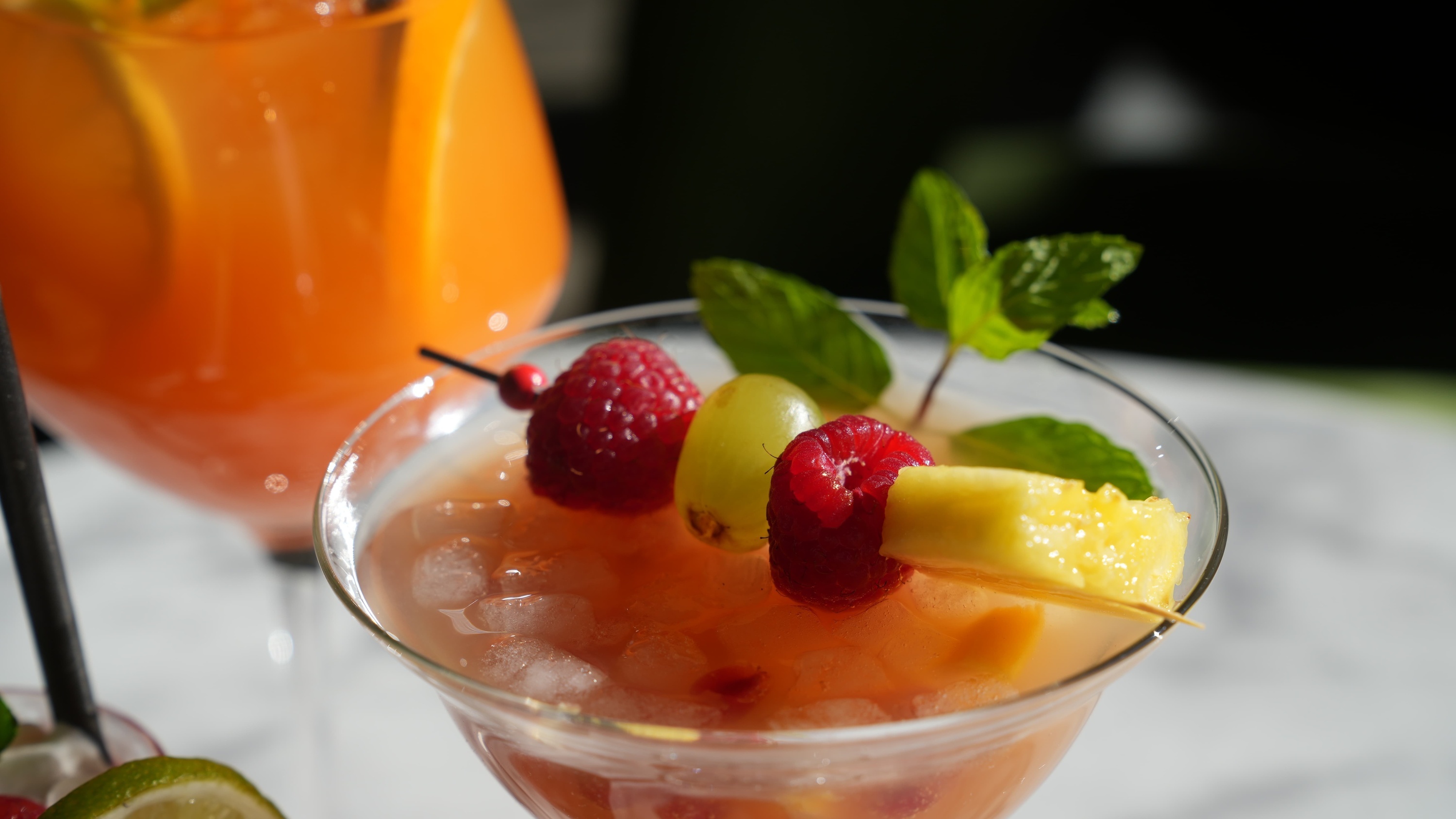 a martini glass filled with fruit and ice