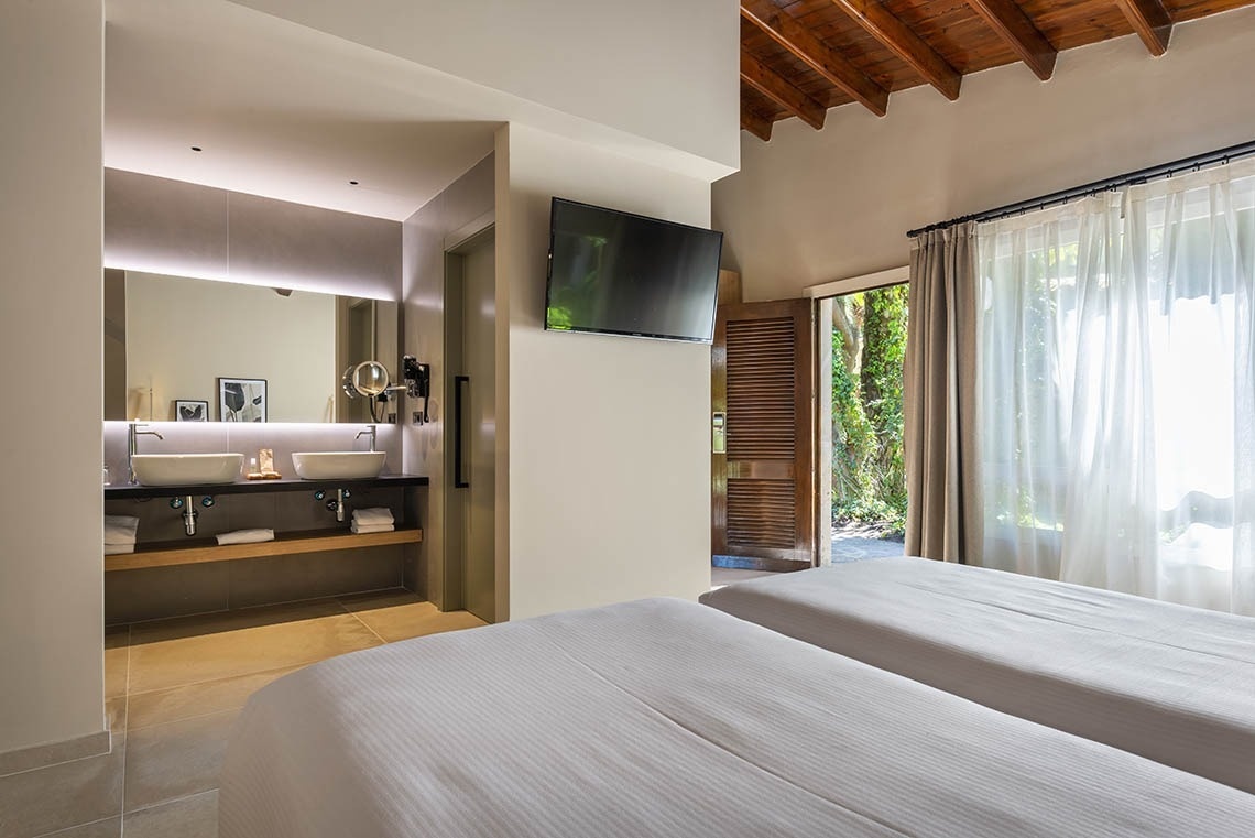 a bathroom with two sinks and a flat screen tv