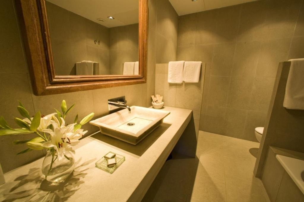 a bathroom with a square sink and a mirror