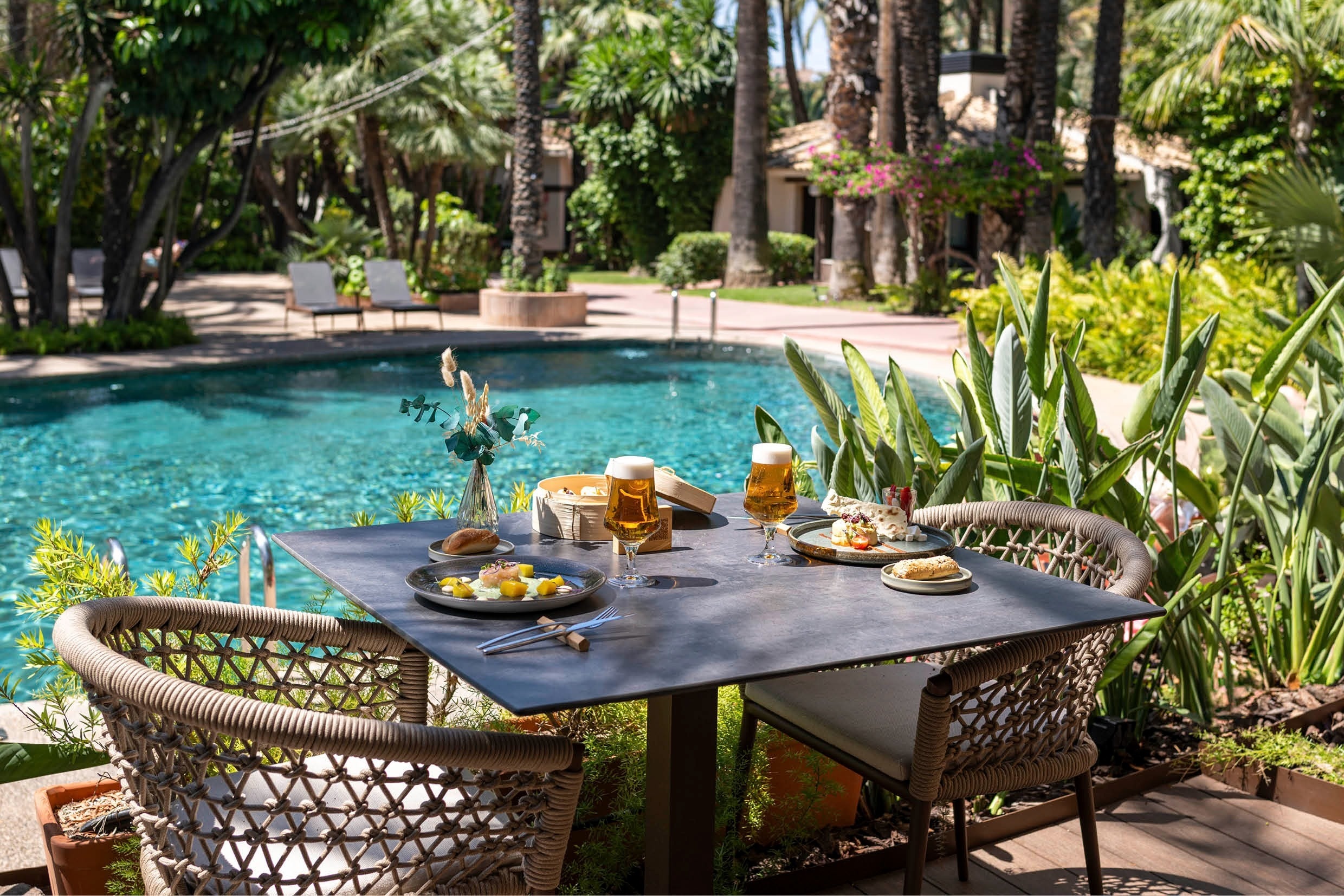 Poolside dining at Port Hotels: Huerto del Cura. Enjoy exquisite outdoor meals.