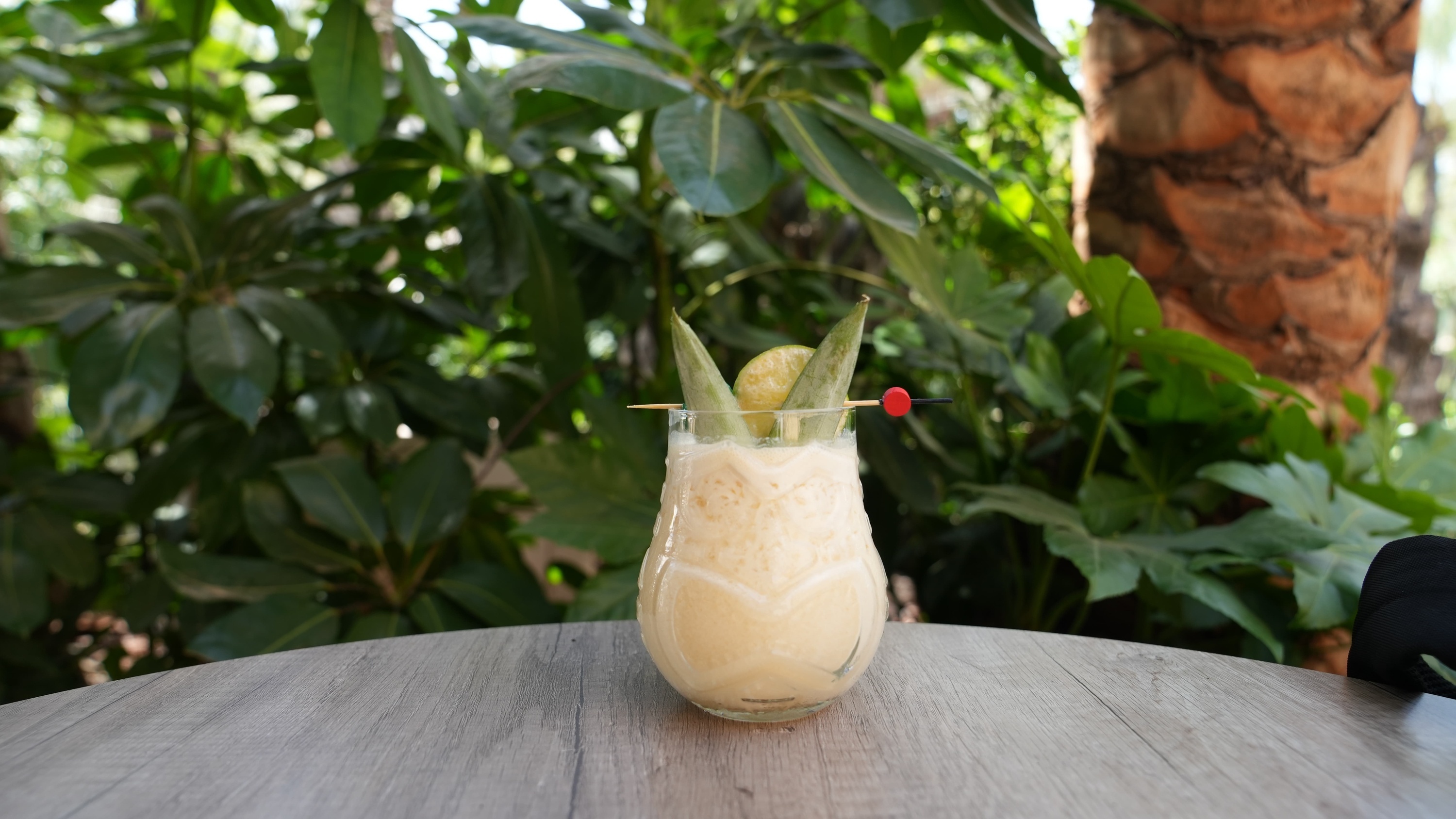 a drink in a pineapple shaped glass with a toothpick in it