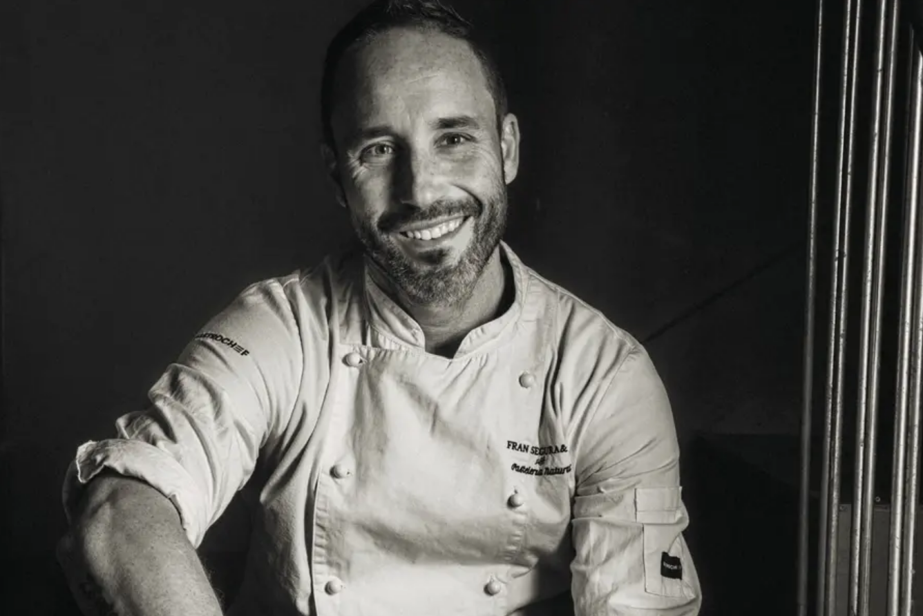 a man and woman toasting with wine glasses in a restaurant