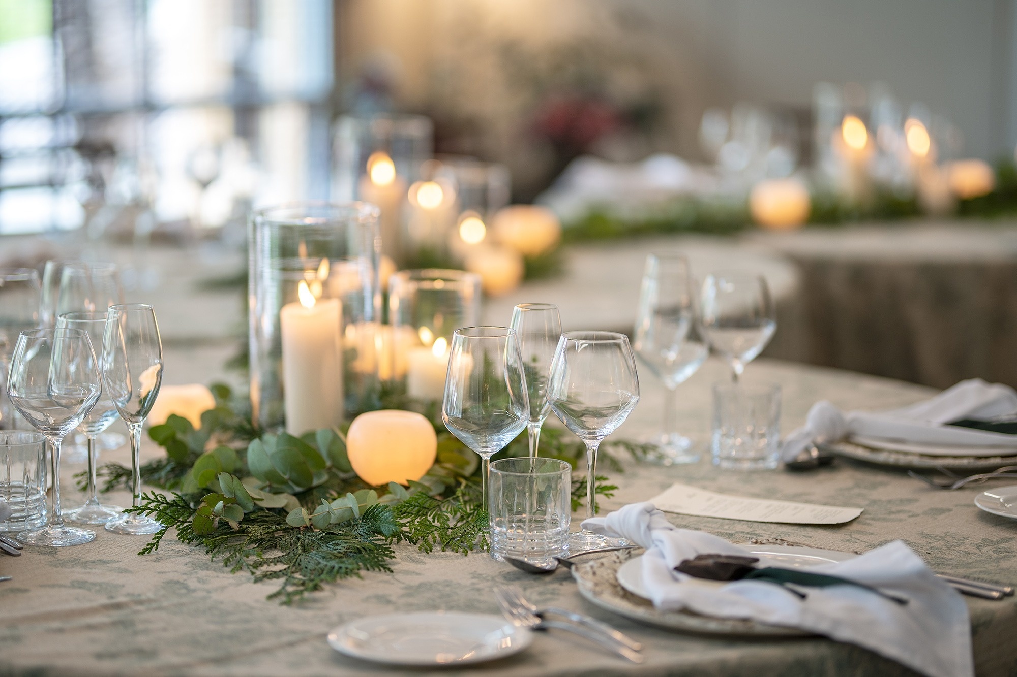 una mesa está decorada con velas y copas de vino