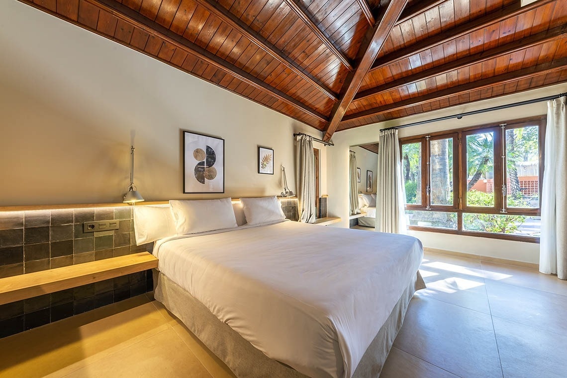 a bedroom with a wooden ceiling and a large bed