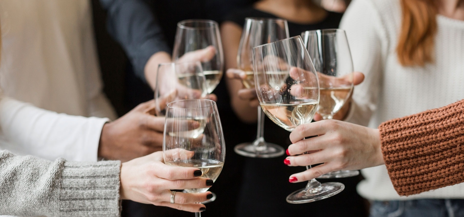 a group of people toasting with wine glasses