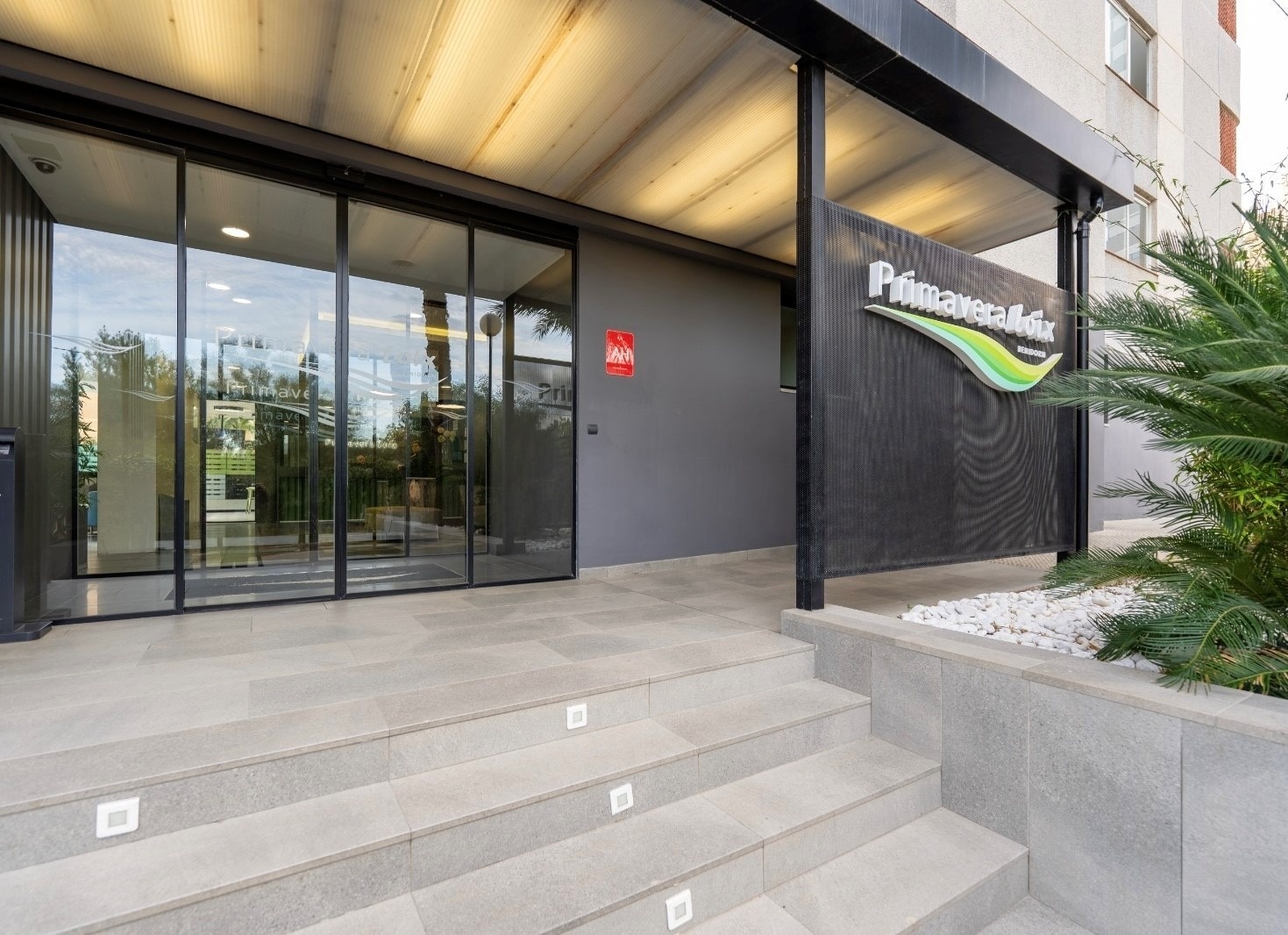 un edificio con una puerta corrediza y un letrero que dice primavera