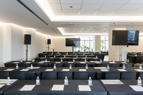 a large room with tables and chairs set up for a meeting