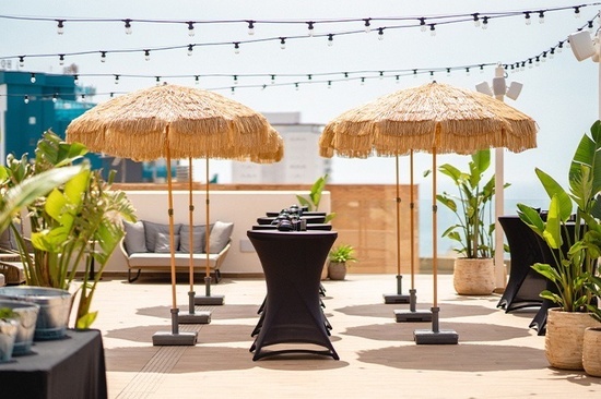 a row of tables and umbrellas on a patio