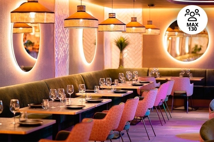 a restaurant with pink chairs and tables with plates and glasses on them