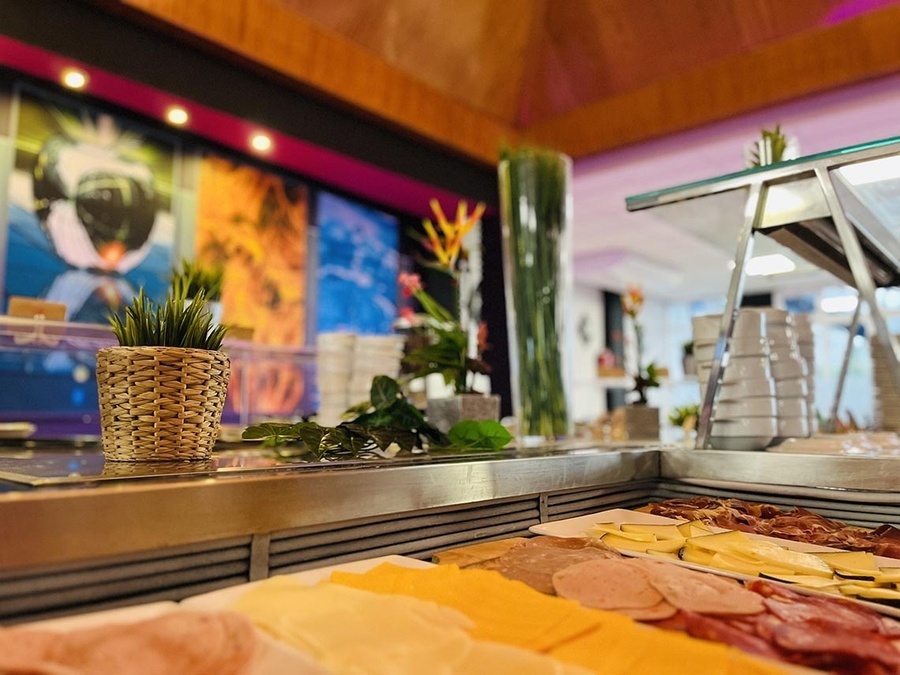 a buffet with a plant in a basket in the foreground