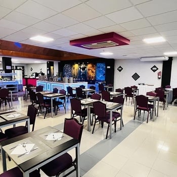 a restaurant with tables and chairs and a fire extinguisher on the wall