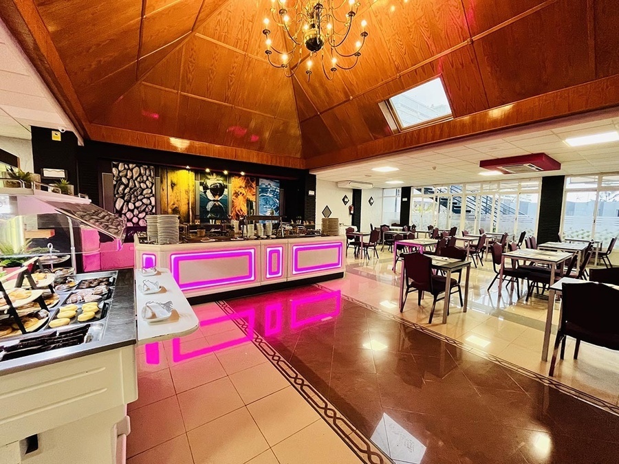 a buffet area in a restaurant with tables and chairs