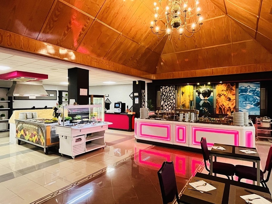 a buffet area in a restaurant with tables and chairs