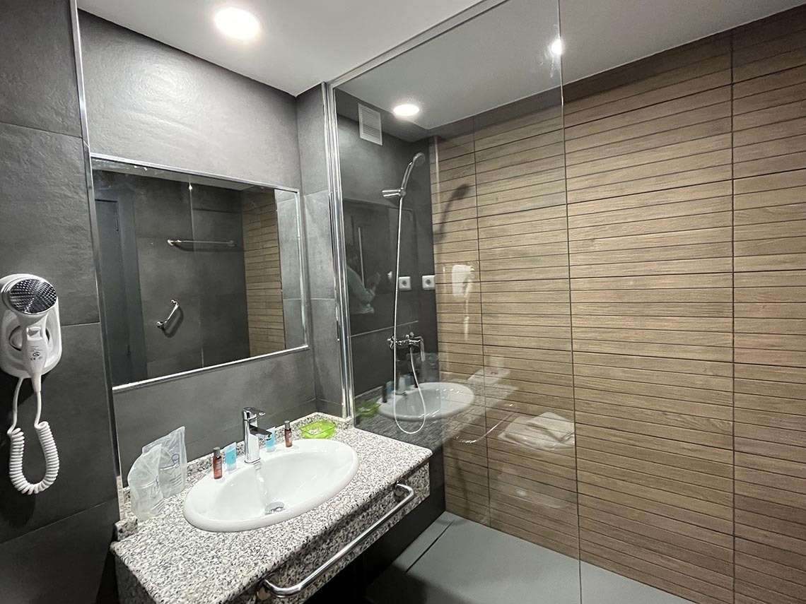 un baño con un lavabo y un secador de pelo