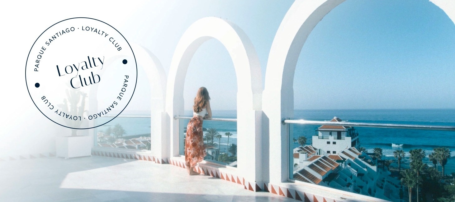 a woman standing on a balcony with a loyalty club logo around her