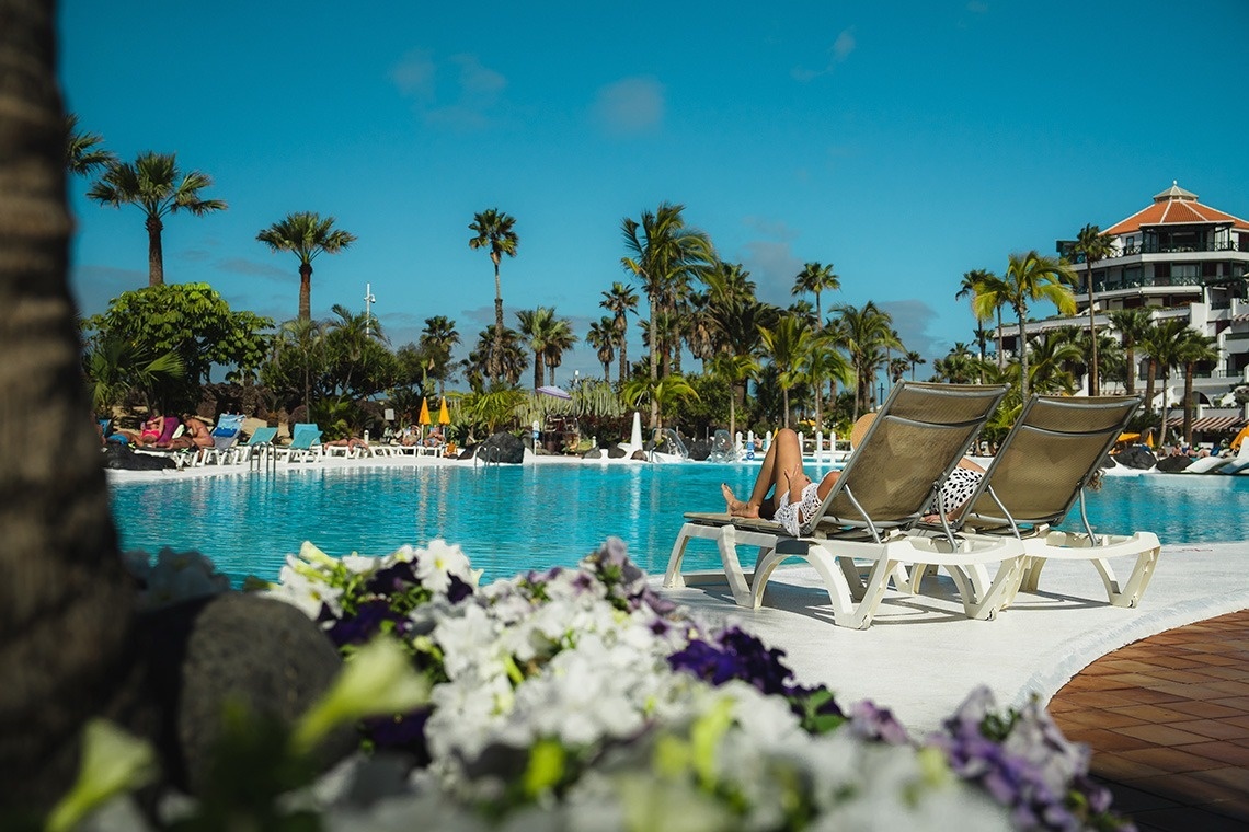 a family standing on a rocky beach looking at the ocean