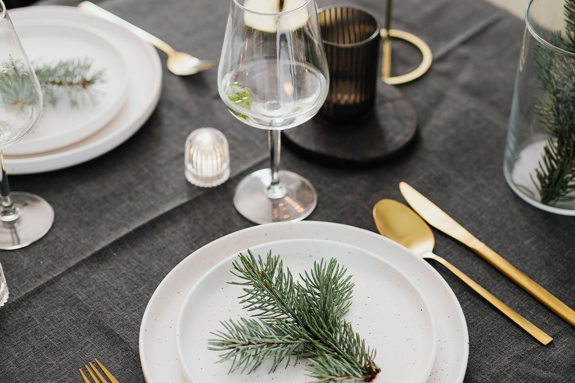 a white plate with a pine branch on it