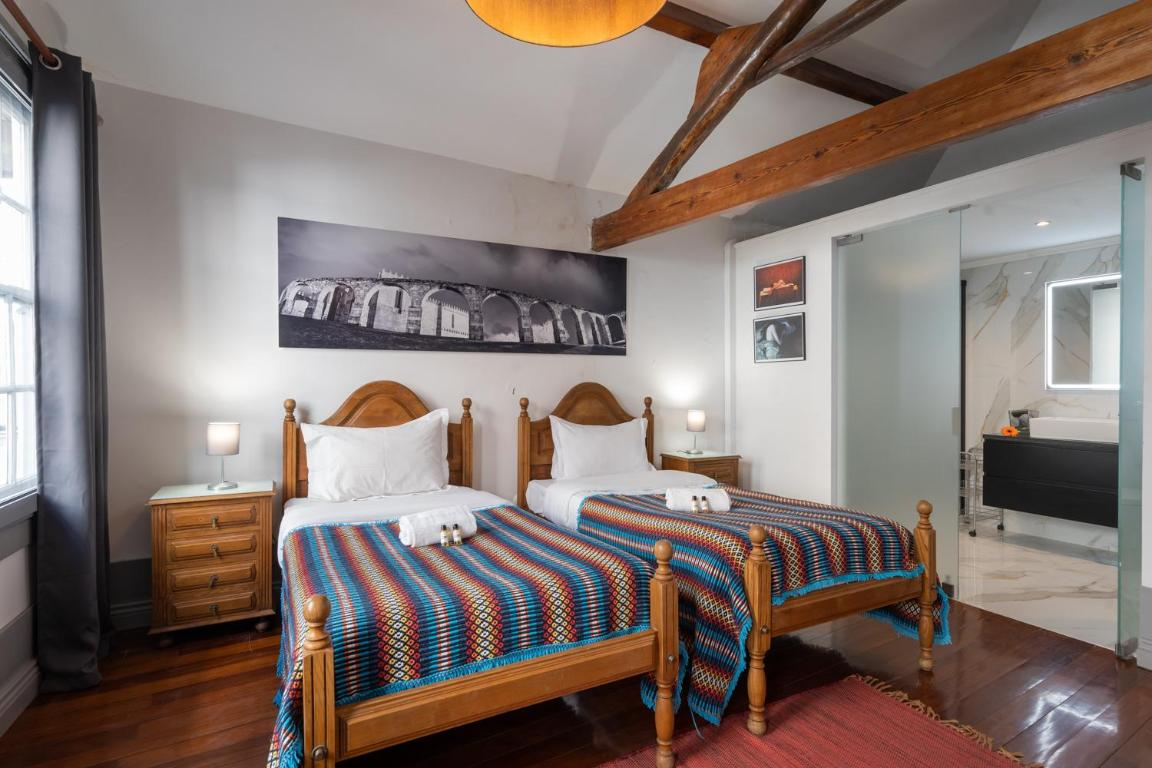 um quarto com duas camas e uma pintura na parede