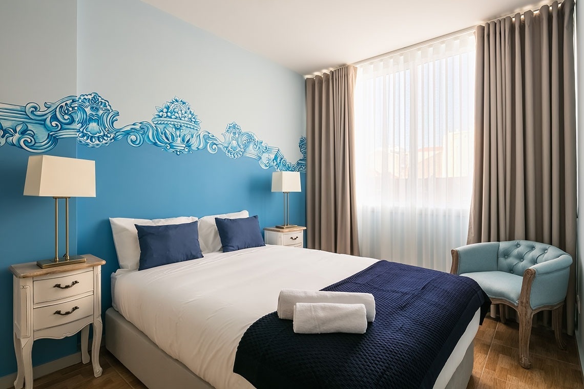 um quarto azul e branco com uma cama king size