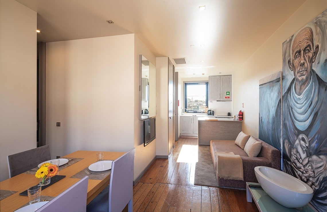 uma sala de jantar com uma mesa e cadeiras e um sofá