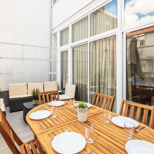 a wooden table with plates and glasses on it