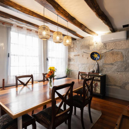 a dining room with a wooden table and chairs