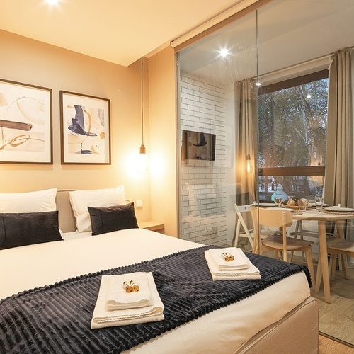 a bedroom with a bed and a table and chairs