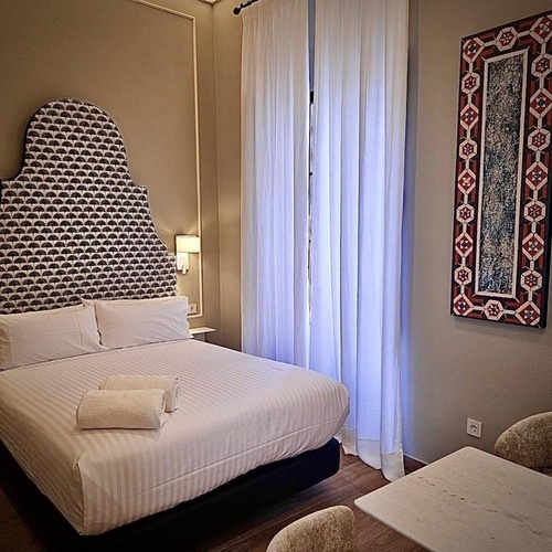 una habitación con una cama y una pintura en la pared