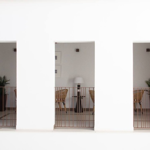 a balcony with a table and chairs and a lamp