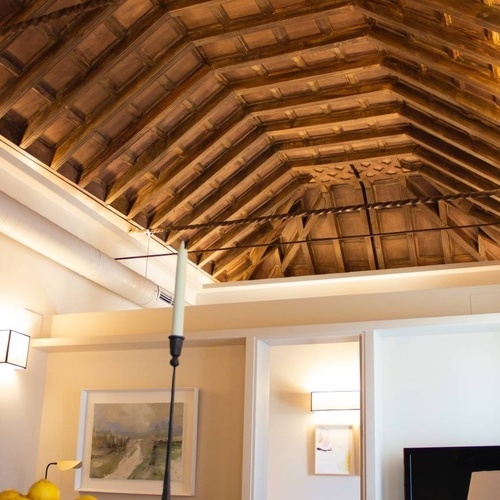 a living room with a wooden ceiling and a plate of lemons on the table