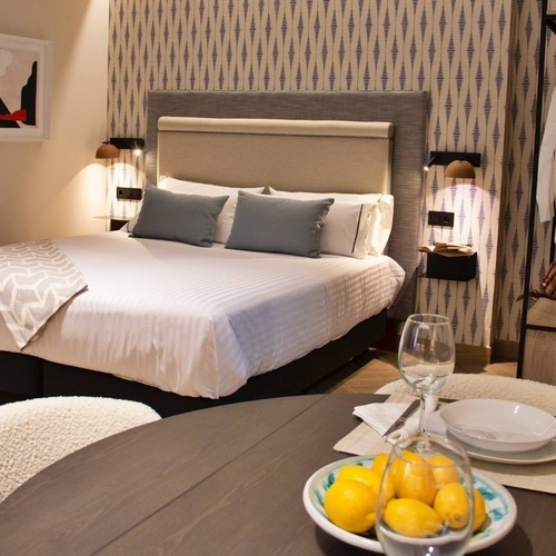 a bedroom with a bed and a table with lemons on it