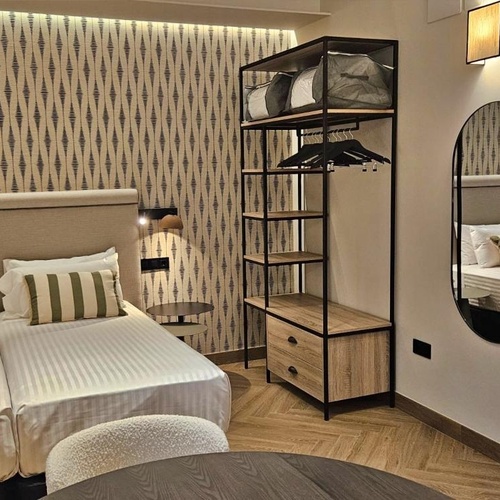 a hotel room with two beds and a mirror