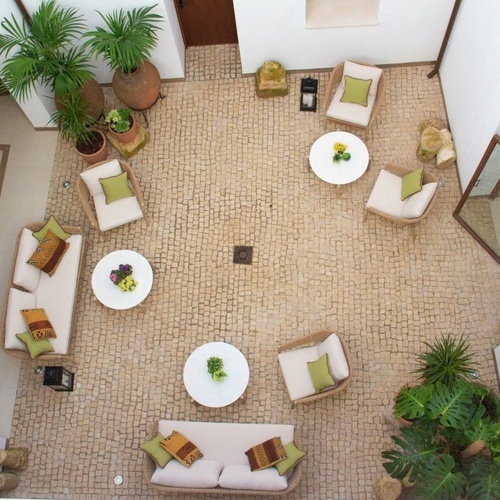 an aerial view of a courtyard with a couch and chairs